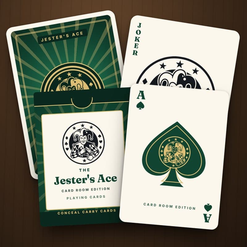 The Jester's Ace Card Room Edition deck: a green tuck box, a green card back with a gold sunburst and jester medallion, the Ace of Spades and the Jester Joker